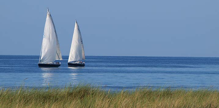 Two white sailboats on the sea